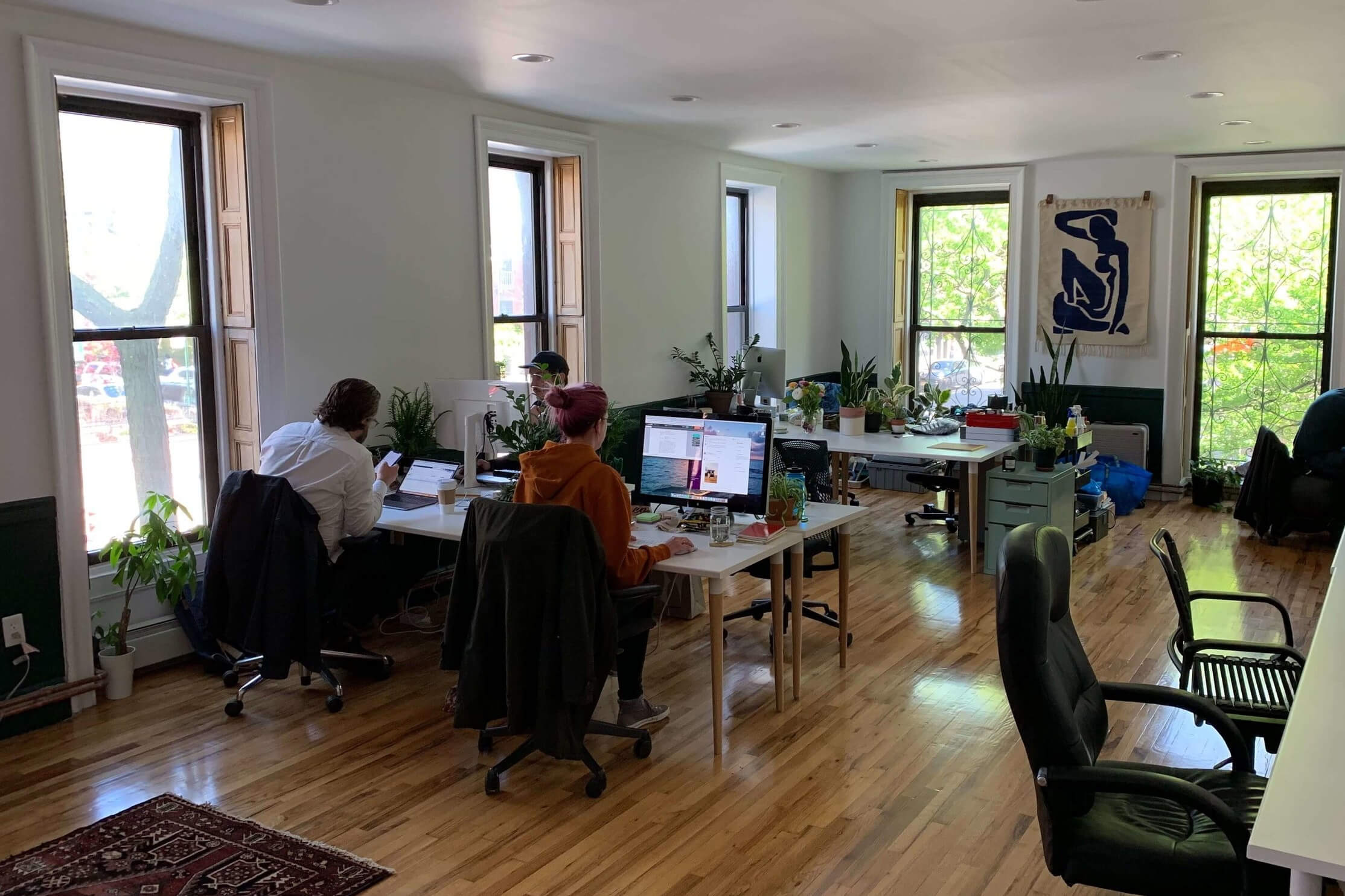 Several people working in a beautiful, well-lit studio space